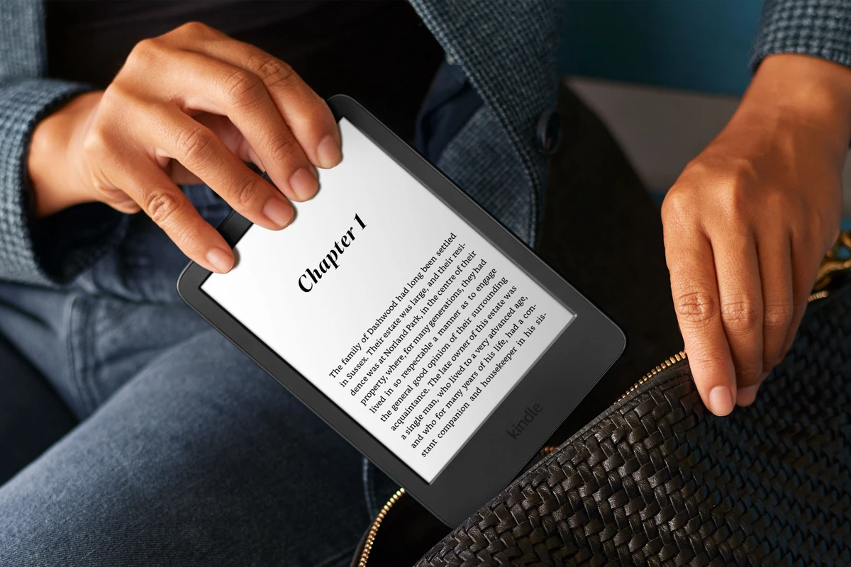 a-hand-holds-the-amazon-kindle-and-puts-the-device-into-a-bag